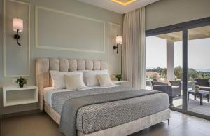 a bedroom with a large bed and a balcony at Villa Anelle in Karavádhos +14 photos