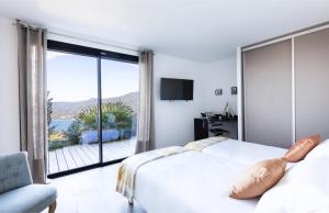 a bedroom with a bed and a window with a view at Villa Supranu in Viggianello