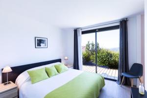 a bedroom with a large bed and a large window at Villa Supranu in Viggianello +21 photos