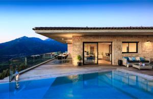 a villa with a swimming pool and a house at Villa Supranu in Viggianello