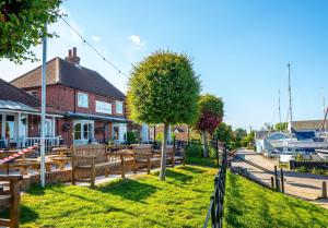 a group of wooden benches in front of a building at The Shepherds Hut at Anvil House in Woodbridge +22 photos