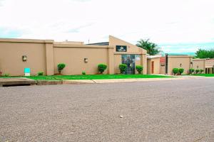 an empty parking lot in front of a building at Sunshine Lodge in Mthatha
