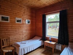 Ένα ή περισσότερα κρεβάτια σε δωμάτιο στο Kaluri Guesthouse