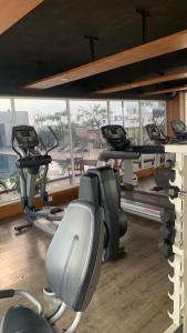 a gym with a row of treadmills and ellipticals at Studentpark apartment by RD in Yogyakarta