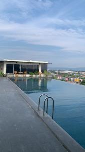 a pool of water with a building in the background at Studentpark apartment by RD in Yogyakarta