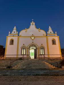 a large church with stairs in front of it at A casa do amor in Vila do Maio