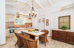 een keuken met een tafel en stoelen bij Villa Valia in Ayios Nikitas +15 foto's