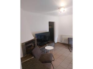 a living room with a television and a chair at Modern Group Home in Bra in Lierneux +29 photos