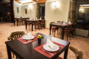 a restaurant with tables and chairs in a room at Pazo de Sedor in Arzúa