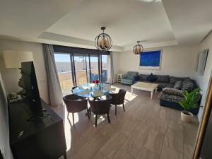 a living room with a table and a couch at Atlantic View Duplex Tawenza Bay in Taghazout