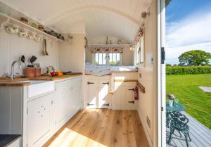 an interior view of a kitchen in a tiny house at The Shepherds Hut at Anvil House in Woodbridge