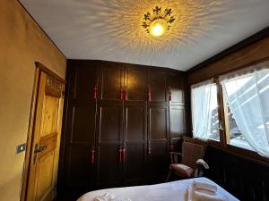 een slaapkamer met een bed en een plafond met een kroonluchter bij Cortina Chalet Skyview in Zuel