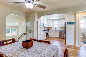 a kitchen and dining room with a table and a ceiling fan at 8 Mi to Dtwn New Orleans! Newly Renovated Home in Metairie