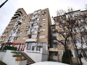 a large apartment building with stairs leading up to it at Cuibul Practic in Oradea