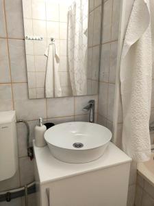 a bathroom with a white sink and a mirror at Cuibul Practic in Oradea +8 photos