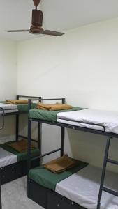 a group of bunk beds in a room at Vilva Premium Multi Sharing Rooms in Madurai