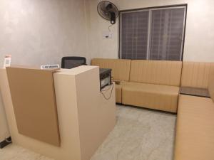 a living room with a couch and a table at Vilva Premium Multi Sharing Rooms in Madurai