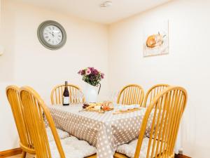 The Barn في Girthon: طاولة غرفة طعام مع طبق من الطعام وساعة +17 صورة