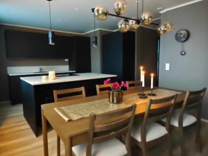 a dining room with a table and chairs with candles at ArticLoft Kemi in Kemi