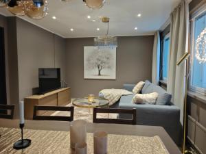 a living room with a blue couch and a tv at ArticLoft Kemi in Kemi