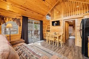 a living room with a couch and a dining room at Tuck River Magic - 6 Waterfront Homes, Fish, Hike, and Mountain Views! in Dillsboro