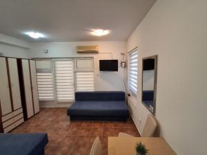 a small living room with a couch and a table at Apartmani Kojovic in Igalo