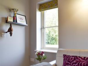 a living room with a window and a couch at White Heather Barn in Swanwick +35 photos