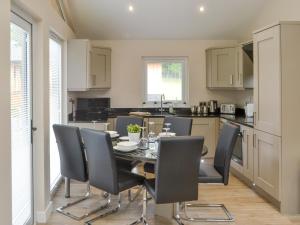 a kitchen and dining room with a table and chairs at Little Fawn in Otterburn