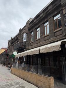 a building on a street with a store at Old Town Hostel Gyumri in Gyumri