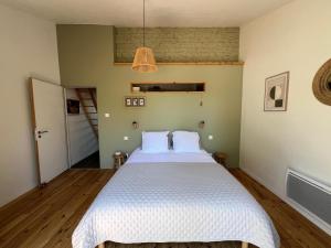 Ένα ή περισσότερα κρεβάτια σε δωμάτιο στο Les Iris - Maison Chaleureuse