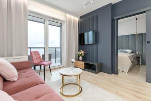 TV a/nebo společenská místnost v ubytování Elegant Apartment with Balcony and Underground Parking by Noclegi Renters + 12 fotografií