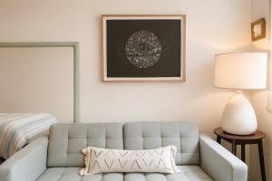 uma sala de estar com um sofá e uma cama em St Kilda Breeze Cosy Oasis em Melbourne