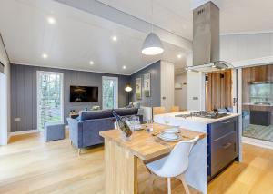 a kitchen and living room with a table and chairs at Elton Furze Retreats in Haddon +18 photos