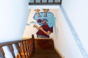 a mural on the side of a stairway at Taladnoi Paint House in Bangkok +56 photos