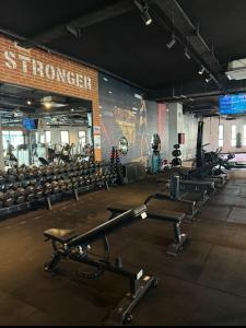 a gym with rows of dumbbells in front of a wall at Caesar Blue Resort Spa Sea view apartment H-49 in Vrysoules +22 photos