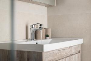 a white sink with a faucet in a bathroom at Loft Nikando in Tsilivi +32 photos