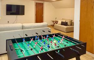 a living room with a table with a large pool table at 5 Bedroom Awesome Home In Lemvig in Nørby