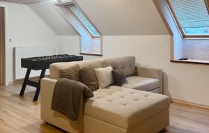 a living room with a couch and a table at 5 Bedroom Awesome Home In Lemvig in Nørby