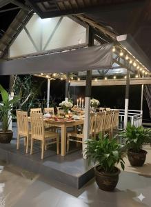 an outdoor dining area with a table and chairs at Pin's House in Bao Loc