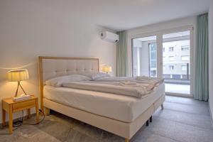 Ένα ή περισσότερα κρεβάτια σε δωμάτιο στο Apartment JungfrauCenter Schynige Platte - GRIWA RENT AG