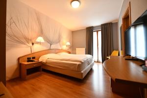 Postel nebo postele na pokoji v ubytování Hotel Piuro