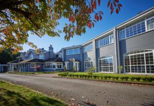a large building with many windows on a street at Stone House Hotel ‘A Bespoke Hotel’ in Stone