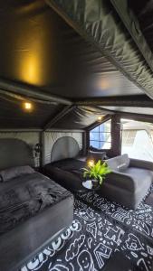 a bedroom with two beds and a couch in a camper at Warisan Homestay Kampung Chinchin in Jasin +40 photos