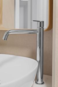 ベルゲンにあるModern and historic apartment 250m from Bryggenの白いトイレの上にあるクロム製の洗面所の蛇口