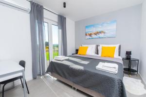 a bedroom with a bed and a desk and a window at Villa Lotta by Istrialux in Labin +21 photos