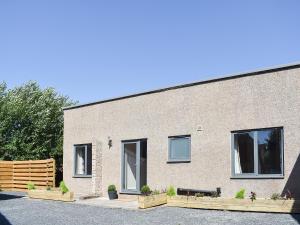a brick building with a bench in front of it at Beckside House in Dalton in Furness