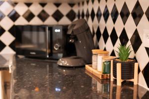 a kitchen counter with a coffee maker and a coffee pot at l'écrin du désir in Capestang