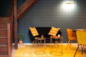 a living room with a couch and two tables and chairs at l'écrin du désir in Capestang
