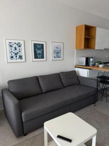 a living room with a couch and a table at Caesar Blue Resort Spa Sea view apartment H-49 in Vrysoules