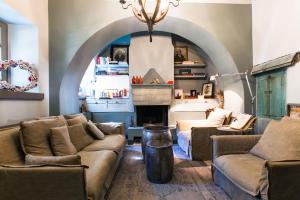 a living room with two couches and a fireplace at Apeiros Chora Hotel in Kato Pedina